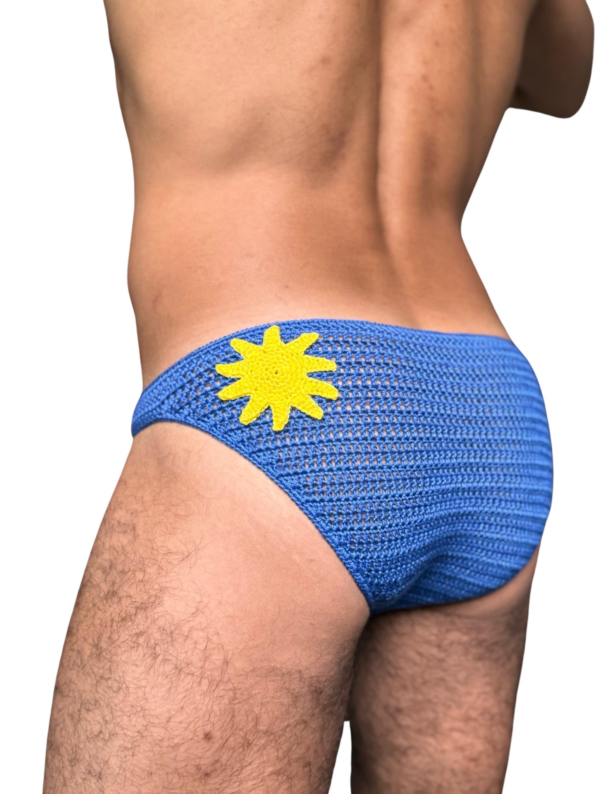 Back close-up of handmade crochet sun briefs for men, showing open stitch design.