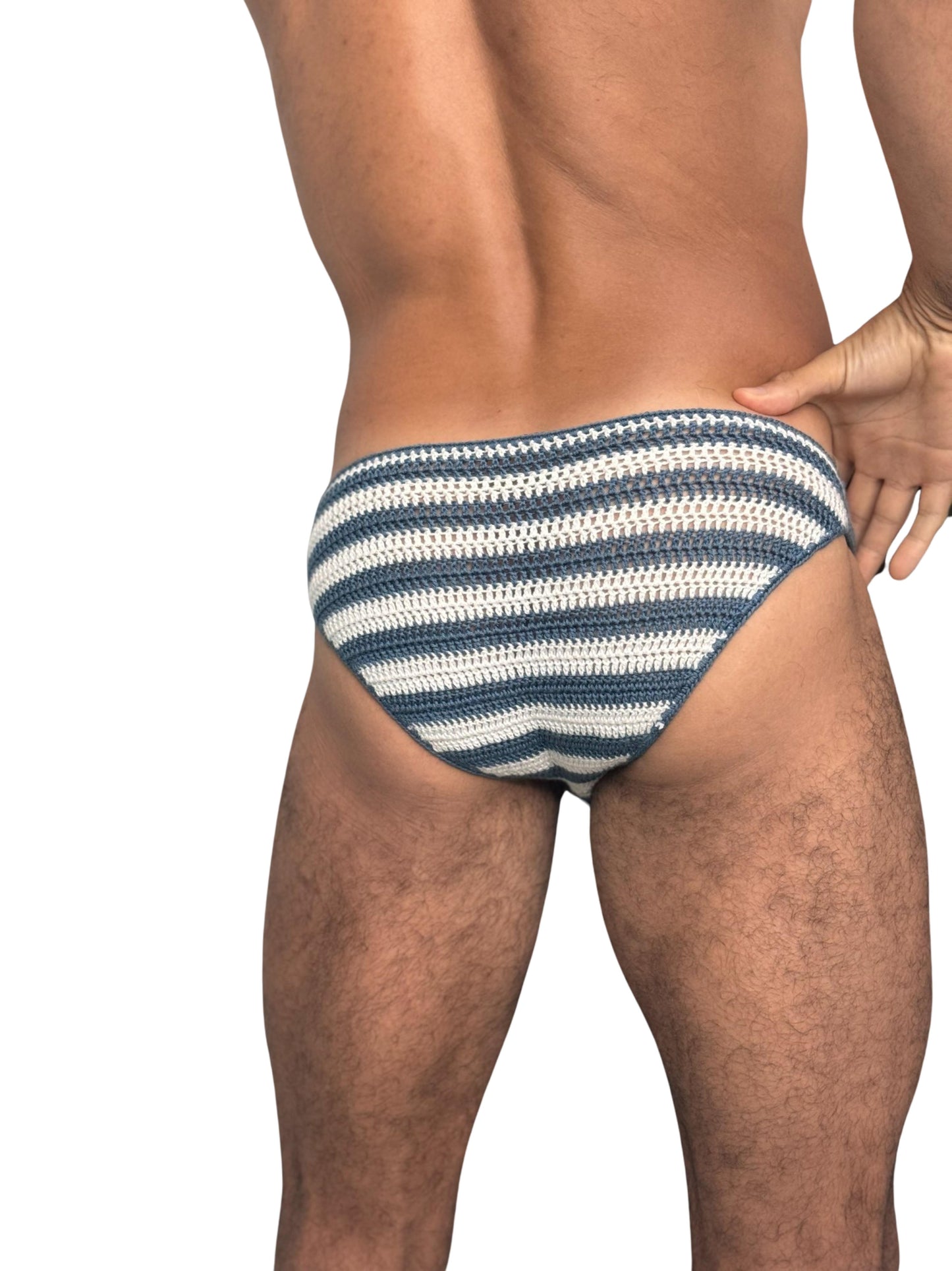 Close-up of multicolor stripes on crochet men’s swim briefs, showing stitch detail and vibrant colors.