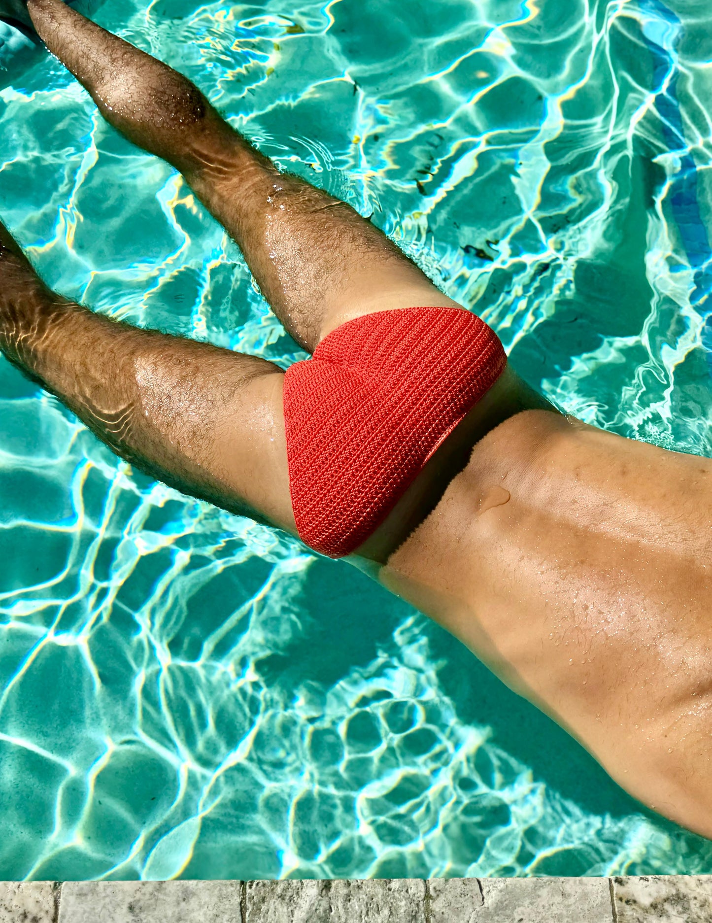 Detail shot of crochet swim briefs leg opening, focusing on edging and craftsmanship.