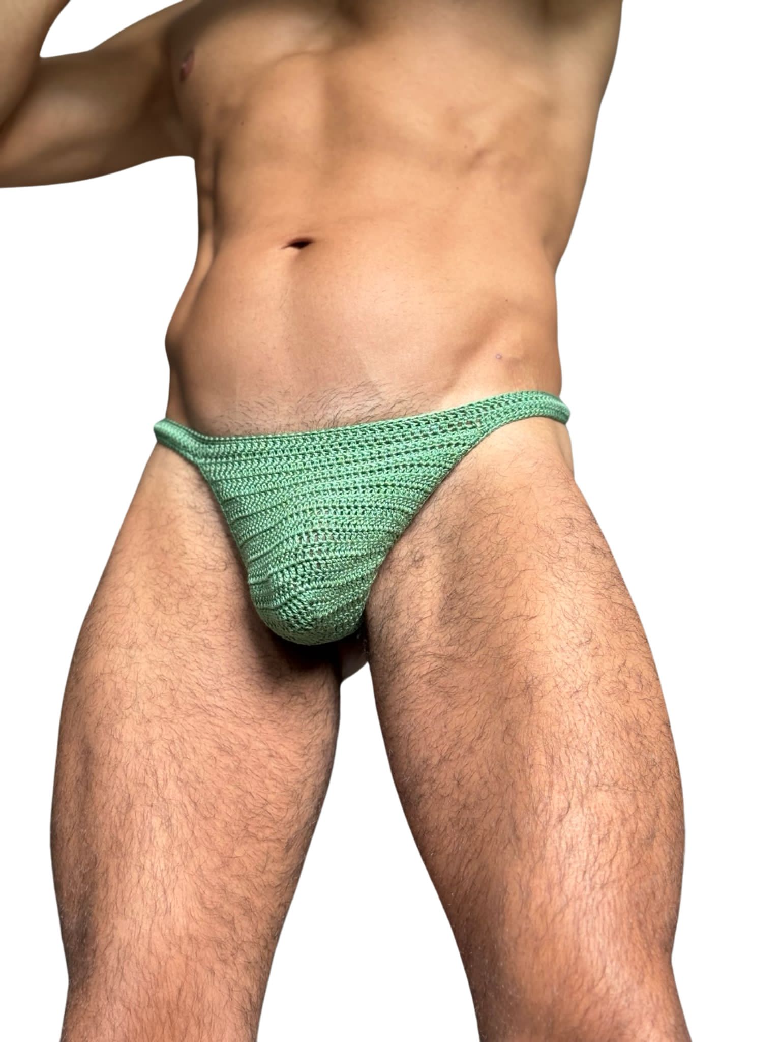 Detail shot of waistband and crochet stitches on men’s thong swimwear, emphasizing craftsmanship.
