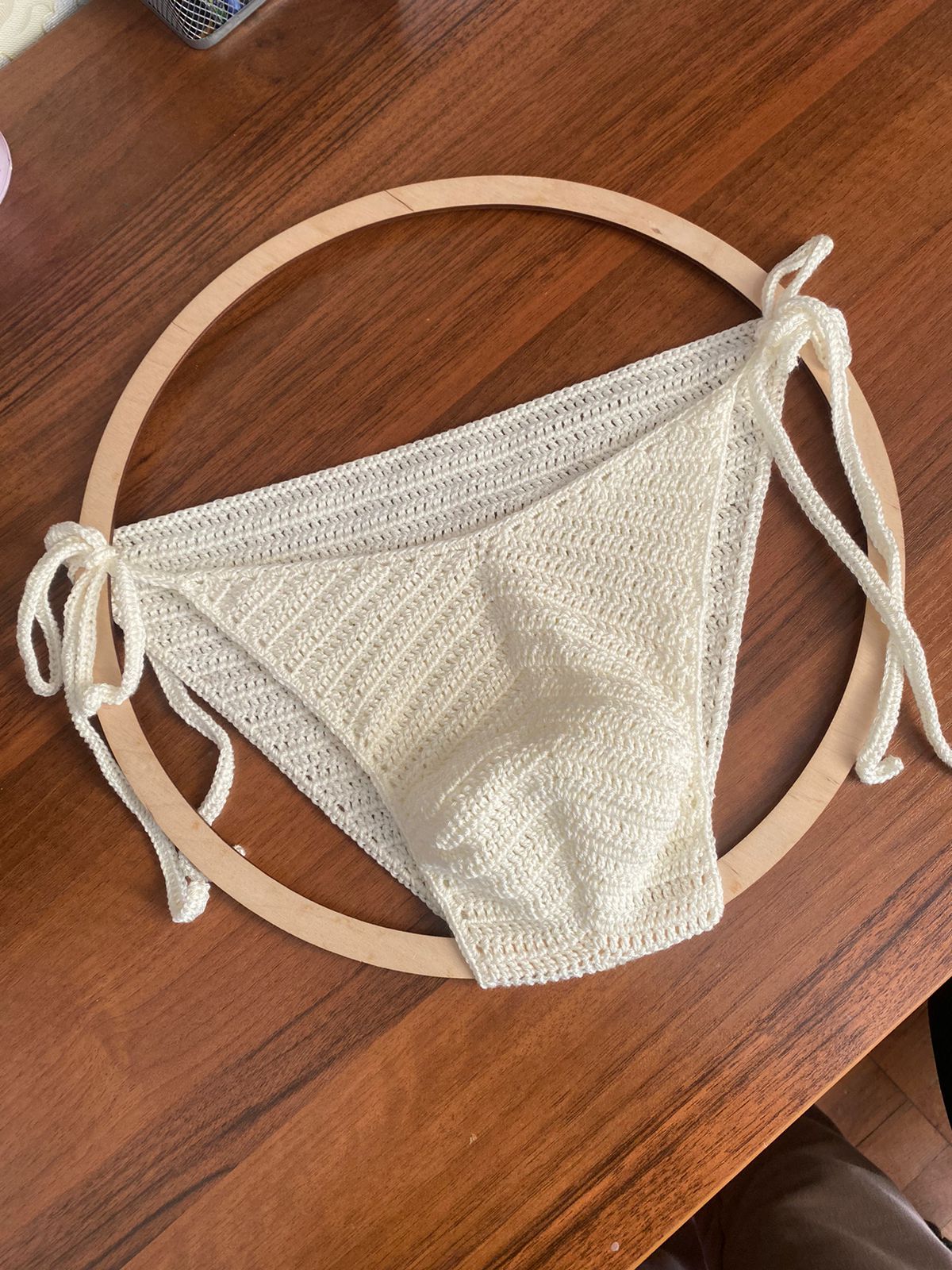 Detail shot of crochet waistband and stitch pattern on men’s tie side swim briefs.