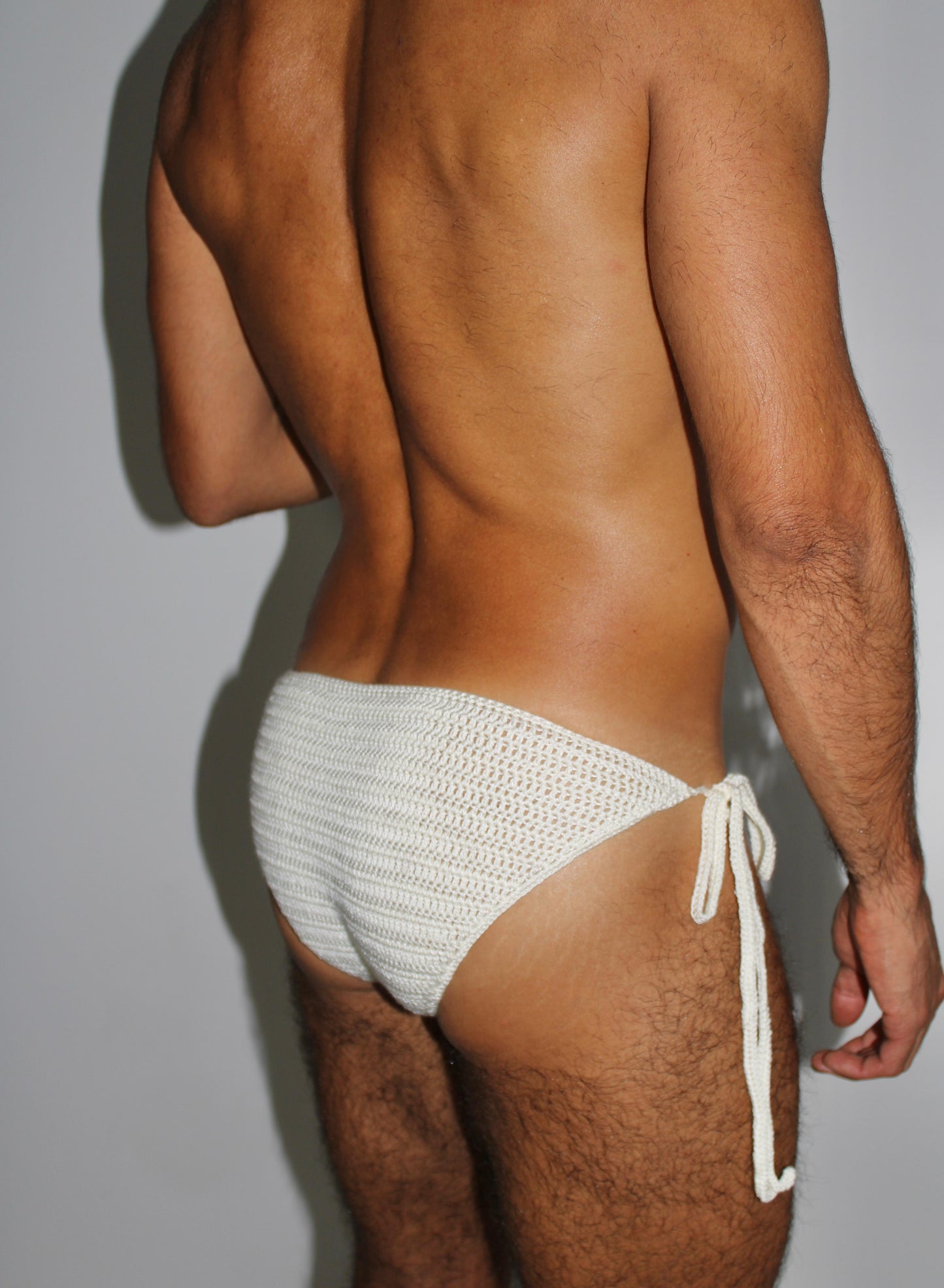 Close-up of crochet stitches on men’s tie side briefs, showing craftsmanship and breathable fabric.