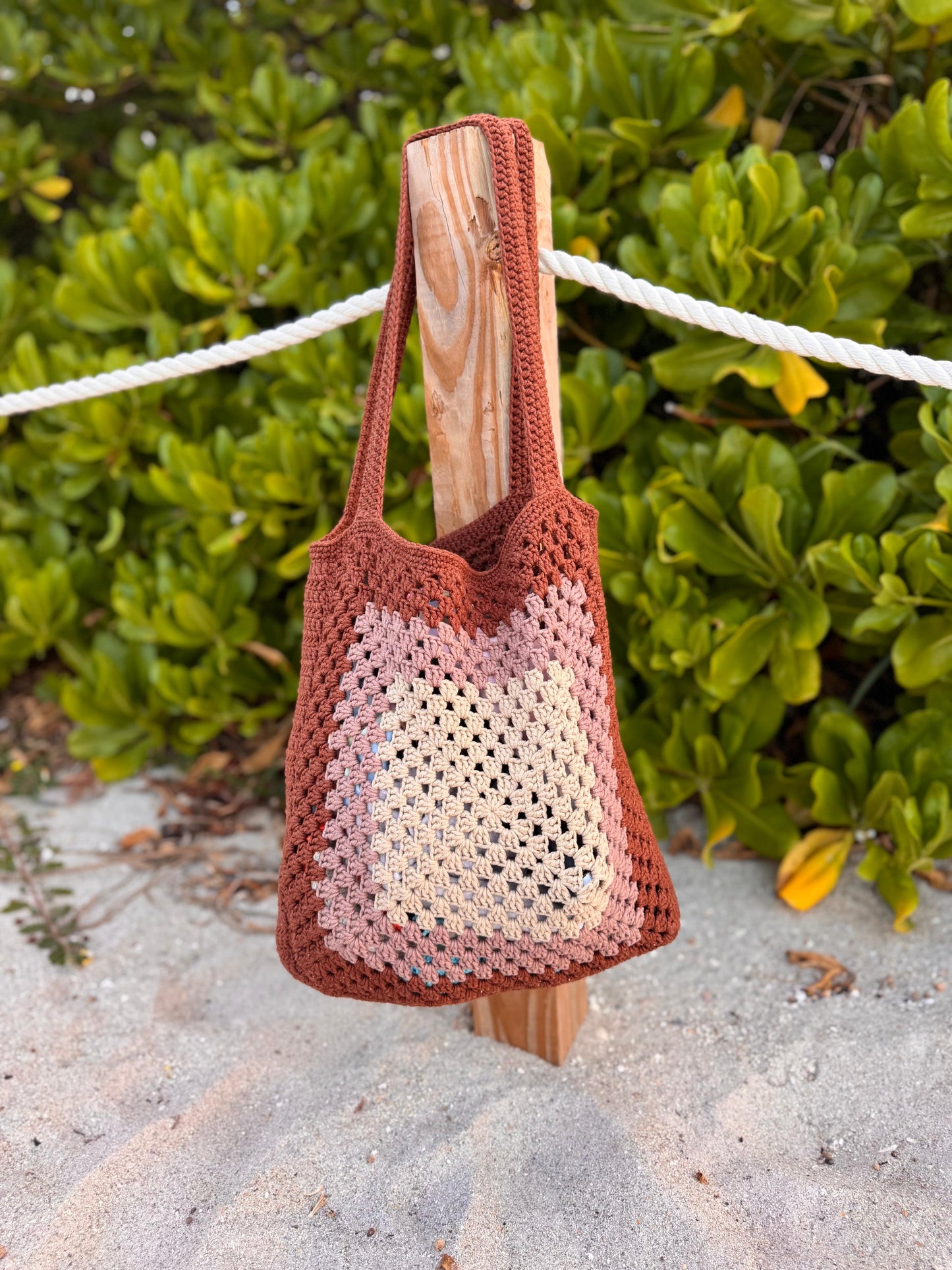 Close-up of crochet stitch texture on beach tote bag, highlighting handmade craftsmanship.