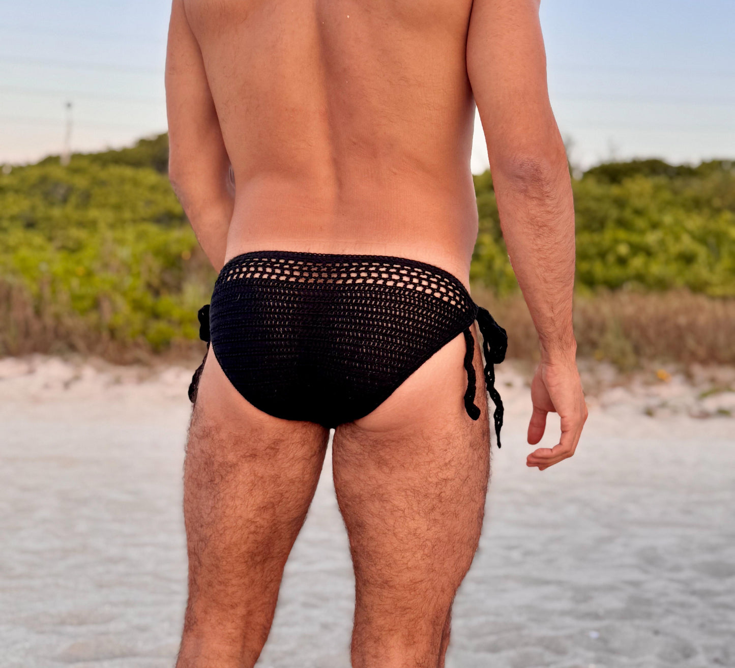 Close-up of tie side detail on crochet men’s swim briefs, showing knot and yarn quality.