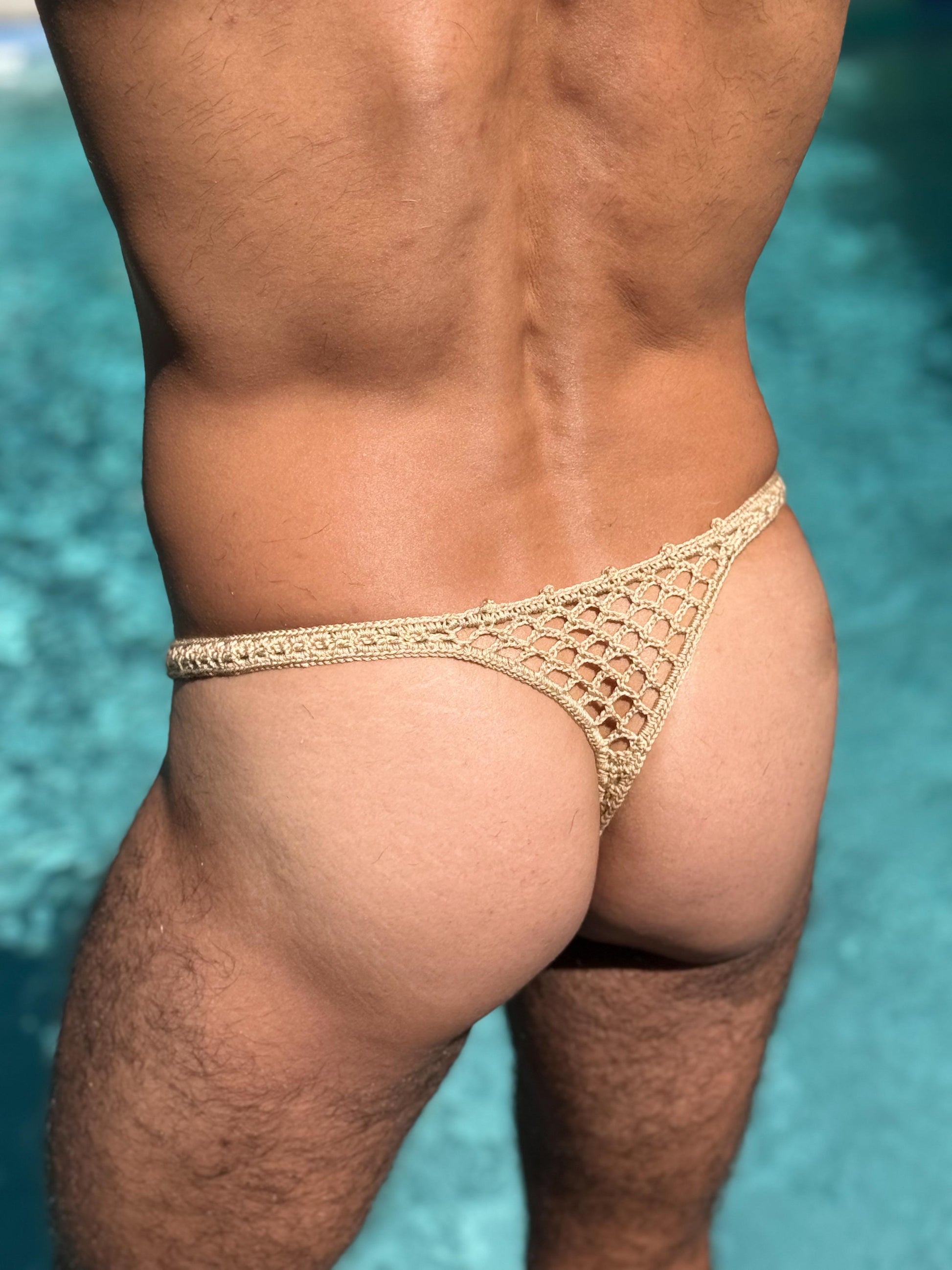 Back view of men’s crochet honeycomb thong swim briefs, highlighting thong cut and airy mesh texture.