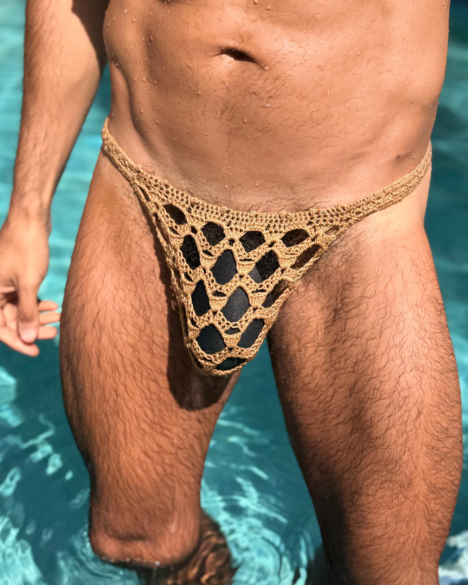 Front view of handmade crochet men’s erotic honeycomb thong swimwear, displayed on a male model.