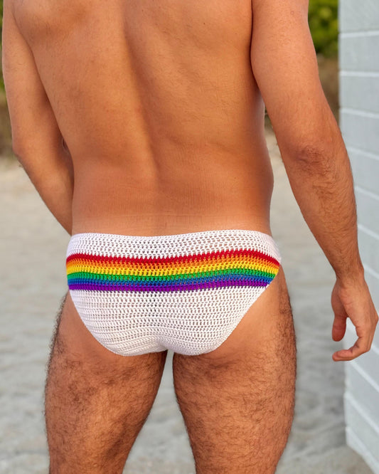 Back view of men’s crochet rainbow swim briefs, highlighting bright stripes and handmade stitch texture.