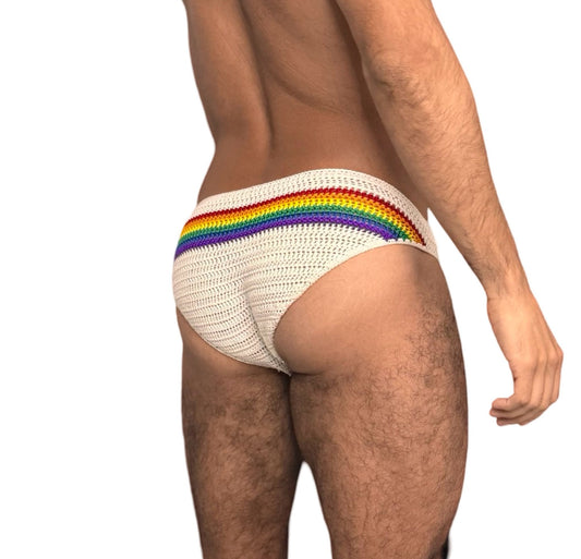 Side angle of crochet rainbow men’s swim briefs, showing vibrant pride stripes and secure fit.