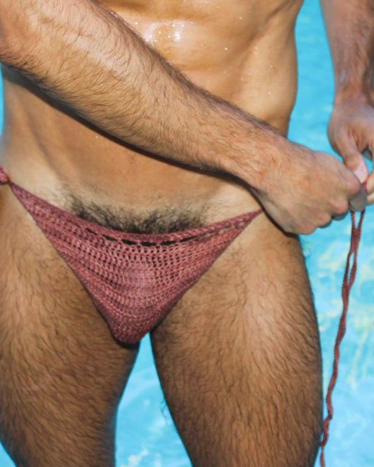 Front close-up of crochet men’s swim briefs with tie sides, emphasizing breathable design and adjustable fit.