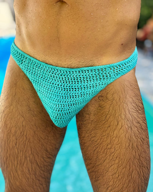 Front view of handmade crochet men's swim briefs, displayed on a man.