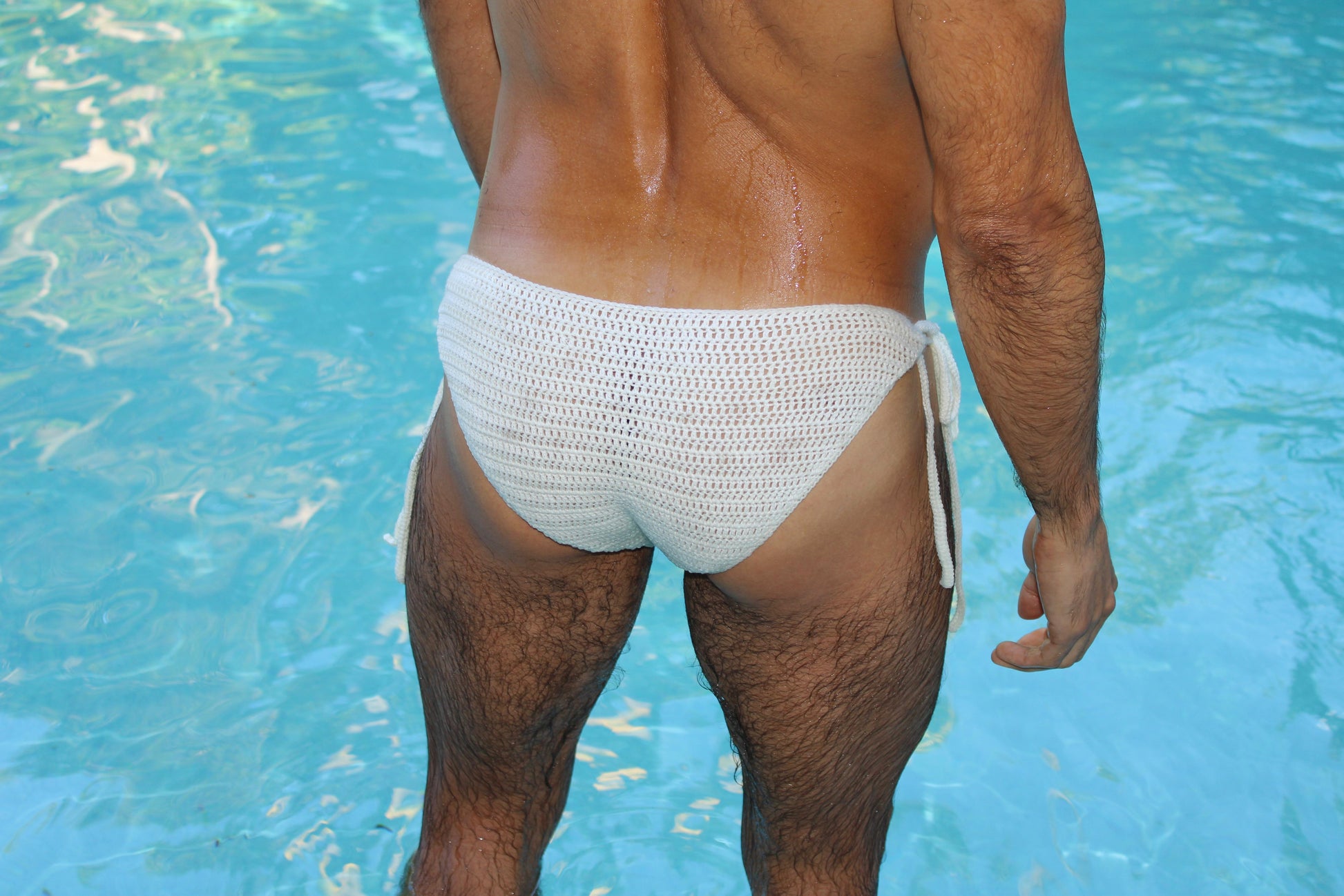 Back angled view of crochet men’s tie side briefs on a model, highlighting comfortable fit and airy structure.