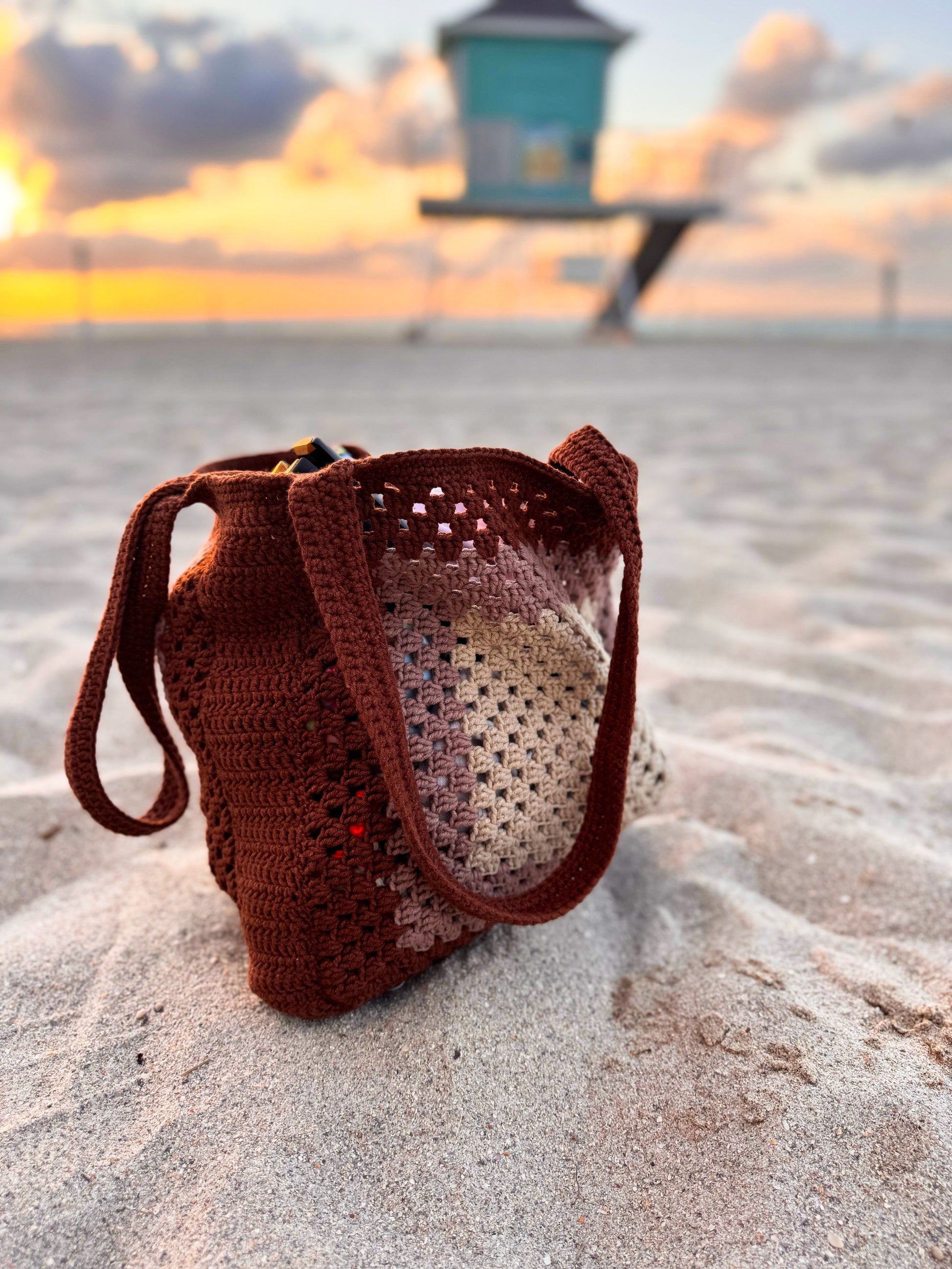 Side angle of crochet beach tote bag, showcasing spacious design and sturdy shoulder straps.