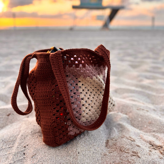 Side angle of crochet beach tote bag, showcasing spacious design and sturdy shoulder straps.