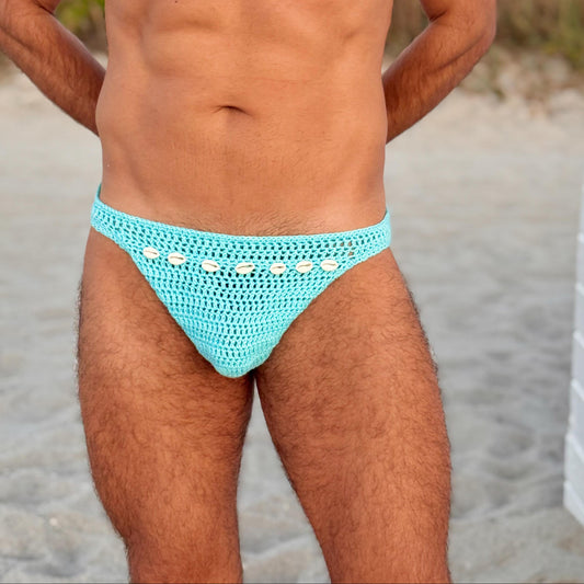 Detail shot of waistband and seashell motif on crochet men’s swim briefs, emphasizing craftsmanship.