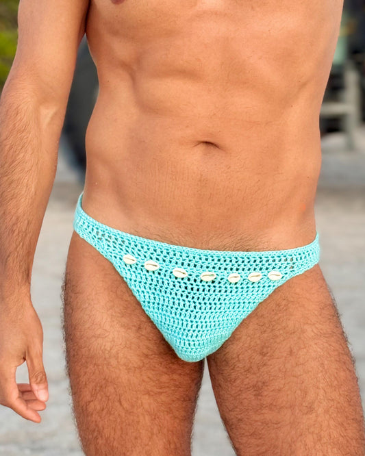 Front view of handmade crochet men’s briefs swimwear with seashells, displayed on a male model.