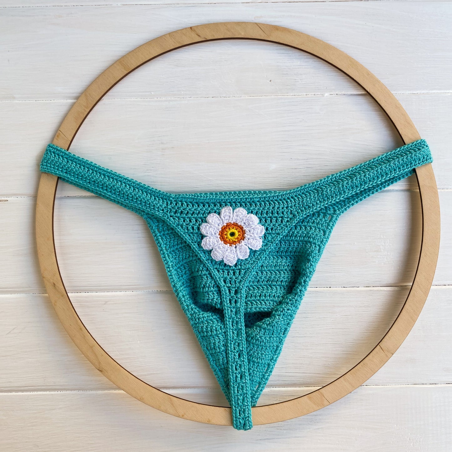 Turquoise handmade crochet mens swim thong with daisy flower beach underwear front view