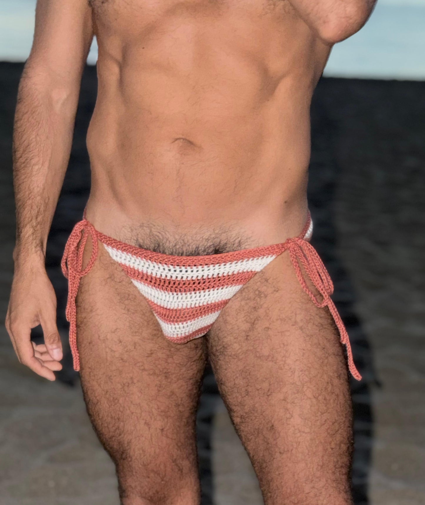 Men's handmade striped crochet swim briefs featuring adjustable tie sides and breathable cotton fabric.
