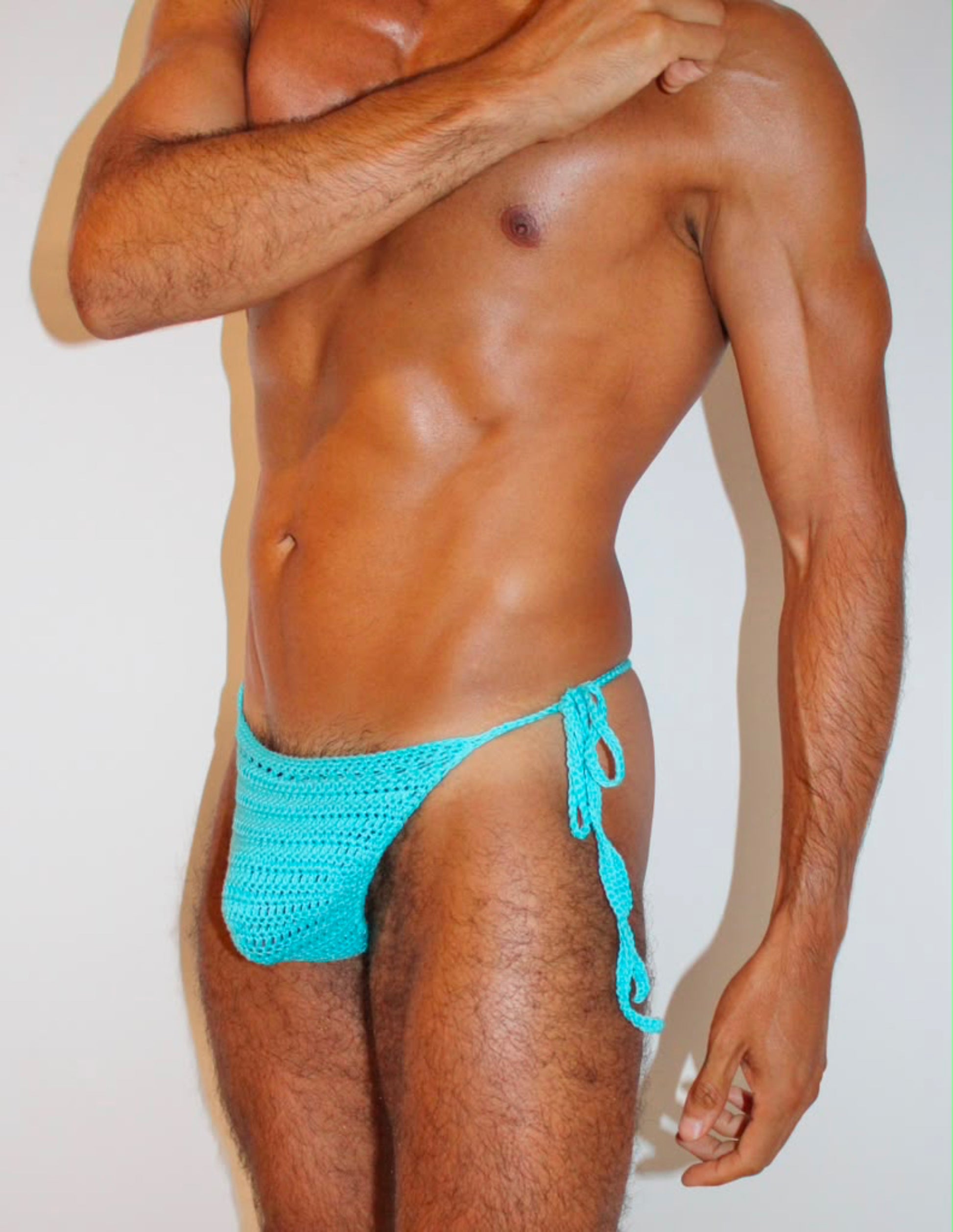 Side view of handmade crochet men's tie side swim thong with adjustable side ties.